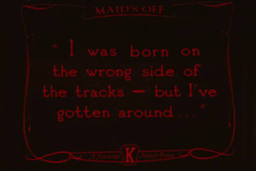 silent movie dialogue card that says “I was born on the wrong side of the tracks — but I’ve gotten around.”