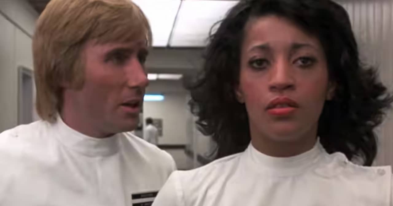 Nurse Cleo looks despondent as Dr. Boyd talks to her from the side