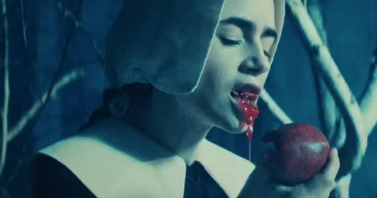 a Puritan woman bites from an apple and blood drips down her chin